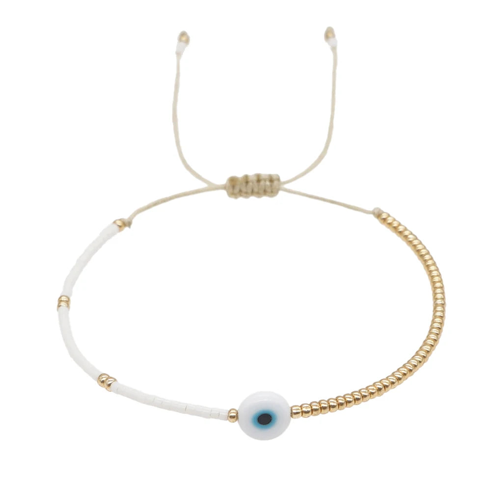 Bracelet œil décoratif et perles dorées
