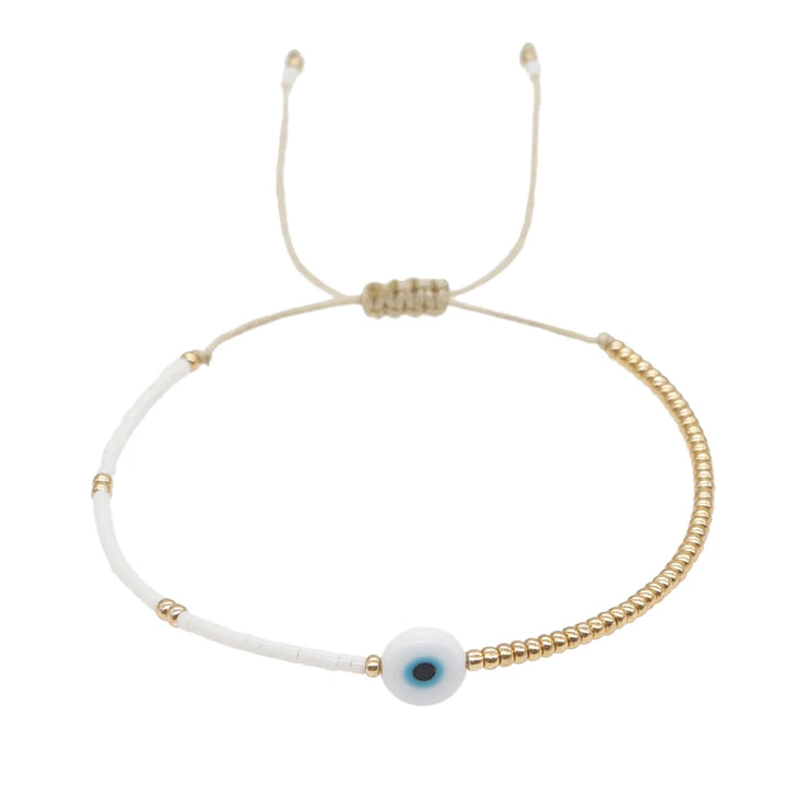 Bracelet œil décoratif et perles dorées