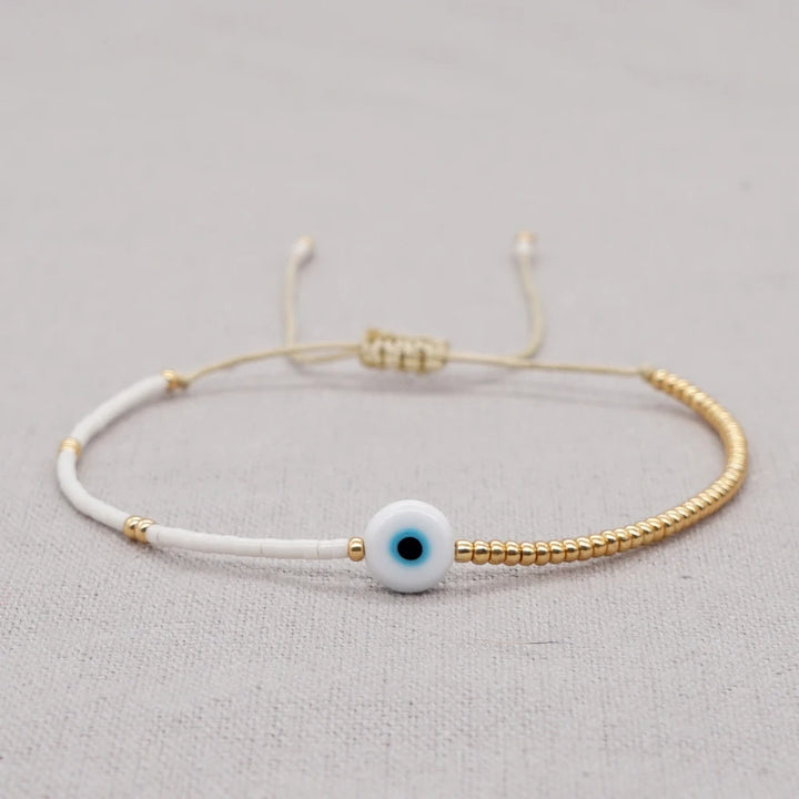 Bracelet œil décoratif et perles dorées